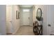 Inviting foyer with tiled floor, decorative console table and front door at 258 Sandoval Dr, Ormond Beach, FL 32174