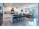Bright kitchen with white cabinets, granite countertops, island, and adjacent dining area at 258 Sandoval Dr, Ormond Beach, FL 32174
