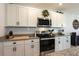 White cabinetry and granite countertops offer plenty of meal prep space in this kitchen at 258 Sandoval Dr, Ormond Beach, FL 32174