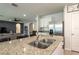 Island sink with granite countertops, stainless appliances, and nearby living area at 258 Sandoval Dr, Ormond Beach, FL 32174