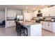 Open kitchen with white cabinets, granite countertops, stainless appliances, and island seating at 258 Sandoval Dr, Ormond Beach, FL 32174