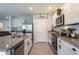 Modern kitchen with white cabinetry, granite countertops, stainless steel appliances, and backsplash at 258 Sandoval Dr, Ormond Beach, FL 32174