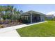 Pool house with manicured lawn and flower bed at 258 Sandoval Dr, Ormond Beach, FL 32174