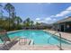 Community pool area featuring a clear pool with chairs at 258 Sandoval Dr, Ormond Beach, FL 32174