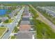 Neighborhood aerial view showcases lush landscaping, sidewalks, community lake and many single Gathering homes at 2672 Star Coral Ln, New Smyrna Beach, FL 32168