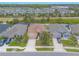 Aerial view of a well-maintained neighborhood showcasing houses with landscaped yards and paved streets at 2672 Star Coral Ln, New Smyrna Beach, FL 32168