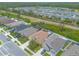 An aerial of the back of several homes with green lawns in a quiet community by a lake at 2672 Star Coral Ln, New Smyrna Beach, FL 32168