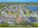 Wide aerial shot of a community showcasing tidy homes along a street, including a peaceful lake at 2672 Star Coral Ln, New Smyrna Beach, FL 32168