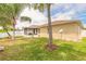Well-maintained backyard with lush green grass, partial fence, and a screened-in lanai attached to the house at 2672 Star Coral Ln, New Smyrna Beach, FL 32168