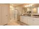 Bathroom featuring a glass shower, double vanity and large mirror at 2672 Star Coral Ln, New Smyrna Beach, FL 32168