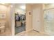 Bathroom featuring a glass shower, and a large walk-in closet with carpeted floors at 2672 Star Coral Ln, New Smyrna Beach, FL 32168