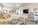 Bright bedroom with a leafy comforter, fan, white dressers and a large television at 2672 Star Coral Ln, New Smyrna Beach, FL 32168