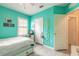 Comfortable bedroom with wood-look floors and a window featuring white shutters at 2672 Star Coral Ln, New Smyrna Beach, FL 32168