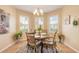 The dining area features a decorative chandelier and three bright windows with stylish shutters at 2672 Star Coral Ln, New Smyrna Beach, FL 32168
