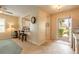 Inviting foyer with tile flooring, an open view of the kitchen, and a bright front door at 2672 Star Coral Ln, New Smyrna Beach, FL 32168