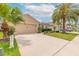 The lovely exterior of the home features an attached two-car garage and a well-maintained lawn and landscaping at 2672 Star Coral Ln, New Smyrna Beach, FL 32168