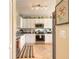 This kitchen features stainless steel appliances, white cabinetry and tile flooring at 2672 Star Coral Ln, New Smyrna Beach, FL 32168