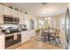 This kitchen features stainless steel appliances, white cabinetry and tile flooring and eat in kitchen at 2672 Star Coral Ln, New Smyrna Beach, FL 32168