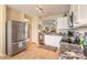This kitchen features stainless steel appliances, white cabinetry and tile flooring at 2672 Star Coral Ln, New Smyrna Beach, FL 32168
