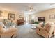 Spacious living room featuring a piano, ceiling fan, and sliding glass doors to the patio at 2672 Star Coral Ln, New Smyrna Beach, FL 32168