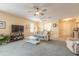 Comfortable living room with a plush sofa, ceiling fans, and a view into the kitchen at 2672 Star Coral Ln, New Smyrna Beach, FL 32168