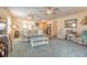 Open concept living room with a plush sofa, ceiling fans, and access to other rooms at 2672 Star Coral Ln, New Smyrna Beach, FL 32168