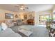 Cozy living room with comfortable seating, ceiling fan, and a view of the patio at 2672 Star Coral Ln, New Smyrna Beach, FL 32168
