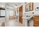 Bright bathroom featuring a large tub, walk-in shower, and dual pedestal sinks at 28 Shadowcreek Way, Ormond Beach, FL 32174