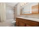 Bathroom features a bathtub, shower, tiled walls, and wood vanity with mirror and lighting at 28 Shadowcreek Way, Ormond Beach, FL 32174