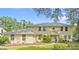 Two-story home with a manicured front yard and mature trees at 28 Shadowcreek Way, Ormond Beach, FL 32174