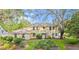 Spacious two-story home with a manicured front yard and mature trees at 28 Shadowcreek Way, Ormond Beach, FL 32174