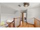 Second floor hallway with wood floors and wooden railing at 28 Shadowcreek Way, Ormond Beach, FL 32174