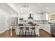 Bright, remodeled kitchen with white cabinetry, an island with bar stool seating, and stainless steel appliances at 28 Shadowcreek Way, Ormond Beach, FL 32174