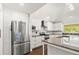 Updated kitchen with white cabinets and stainless steel appliances at 28 Shadowcreek Way, Ormond Beach, FL 32174