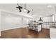 Spacious living area featuring wood floors, high ceilings, and a beautifully remodeled kitchen in the background at 28 Shadowcreek Way, Ormond Beach, FL 32174