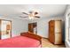 Well-lit bedroom featuring hard floors, a ceiling fan, a bathroom and an open doorway at 28 Shadowcreek Way, Ormond Beach, FL 32174