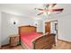 Bedroom featuring wood floors, ornate furniture, a ceiling fan, and an attached bathroom at 28 Shadowcreek Way, Ormond Beach, FL 32174