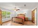 Ornate bedroom with wood furniture, wood floors, a ceiling fan and natural light at 28 Shadowcreek Way, Ormond Beach, FL 32174