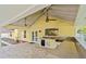 Covered outdoor kitchen featuring bar seating, sink, mini-fridge, and lots of counter space at 28 Shadowcreek Way, Ormond Beach, FL 32174
