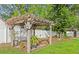 Charming backyard pergola with climbing plants and a birdhouse at 28 Shadowcreek Way, Ormond Beach, FL 32174