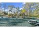 Community playground with multiple play structures, a picnic table, and a safe, cushioned ground surface at 28 Shadowcreek Way, Ormond Beach, FL 32174