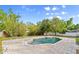 Inviting in-ground pool with patio seating surrounded by lush landscaping at 28 Shadowcreek Way, Ormond Beach, FL 32174