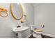 Half bath featuring a pedestal sink, wood accents, and traditional fixtures at 28 Shadowcreek Way, Ormond Beach, FL 32174