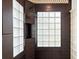 Shower with brown tile, shower head, glass block window and natural light at 28 Shadowcreek Way, Ormond Beach, FL 32174