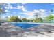 Well-maintained tennis court with lighting allows for daytime and nighttime games at 28 Shadowcreek Way, Ormond Beach, FL 32174