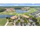 Aerial view of the community featuring a golf course, clubhouse, and scenic lake at 2811 S Asciano Ct, New Smyrna Beach, FL 32168