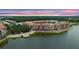 Scenic aerial view of a waterfront building surrounded by lush trees, offering serene residential living at 2811 S Asciano Ct, New Smyrna Beach, FL 32168