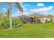 Beautiful backyard with a screened lanai, lush landscaping, and well-maintained lawn, perfect for outdoor enjoyment at 2811 S Asciano Ct, New Smyrna Beach, FL 32168