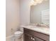 Bathroom featuring granite vanity with dark wood cabinets and modern fixtures at 2811 S Asciano Ct, New Smyrna Beach, FL 32168