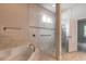 Bathroom featuring a large soaking tub with tile surround and glass enclosed shower at 2811 S Asciano Ct, New Smyrna Beach, FL 32168
